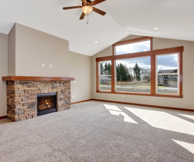 clean living room with fireplace and large windows